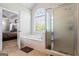 Bathroom featuring soaking tub, shower, tiled floors, and great natural light at 2060 Dixie Rd, Covington, GA 30014