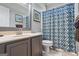 A bathroom view showing sink, shower, toilet and a floral shower curtain at 2060 Dixie Rd, Covington, GA 30014