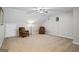 A spacious bonus room with two plush chairs, neutral walls and carpeted floors at 2060 Dixie Rd, Covington, GA 30014