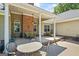 Inviting covered patio with brick accents, comfortable seating, and outdoor dining area at 2060 Dixie Rd, Covington, GA 30014