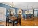 Light-filled dining room that flows into the kitchen area, featuring wood floors and pendant lighting at 2060 Dixie Rd, Covington, GA 30014