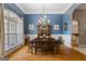 Formal dining area with stylish decor, hardwood flooring, large window and view into living area at 2060 Dixie Rd, Covington, GA 30014