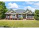Beautifully landscaped brick home with manicured lawn and a welcoming front porch at 2060 Dixie Rd, Covington, GA 30014