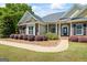 Well-maintained brick home with a manicured lawn, walkway, and updated landscaping at 2060 Dixie Rd, Covington, GA 30014