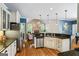 Open kitchen featuring stainless steel appliances, island with sink, granite counters, and hardwood flooring at 2060 Dixie Rd, Covington, GA 30014