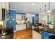 Well-lit kitchen featuring stainless steel appliances, granite counters, hardwood floors, and blue accent wall at 2060 Dixie Rd, Covington, GA 30014