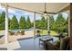 Inviting covered patio featuring ample seating and a refreshing view of the sparkling pool and landscaped backyard at 2060 Dixie Rd, Covington, GA 30014