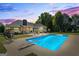 Backyard retreat featuring a large in-ground pool, patio area, and cozy fire pit, perfect for outdoor entertaining at 2060 Dixie Rd, Covington, GA 30014