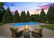 Inviting poolside setting with comfortable chairs around a fire pit, perfect for enjoying cool evenings at 2060 Dixie Rd, Covington, GA 30014