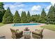 Beautiful backyard featuring an in-ground pool, a fire pit, and lounge chairs for outdoor enjoyment at 2060 Dixie Rd, Covington, GA 30014