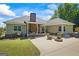 Rear exterior featuring a patio with outdoor seating, fire pit, and well-maintained lawn at 2060 Dixie Rd, Covington, GA 30014