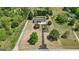 Aerial view showcases long driveway, mature trees, and lush lawn at 424 N Green Cir, Mcdonough, GA 30252