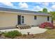 Back of house with a patio, manicured landscaping, and a lush green lawn at 424 N Green Cir, Mcdonough, GA 30252