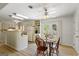 Kitchen dining area features wooden table set, updated lighting, french doors overlooking the backyard at 424 N Green Cir, Mcdonough, GA 30252