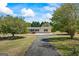 Charming home featuring a long driveway, attractive landscaping, and a well-manicured lawn at 424 N Green Cir, Mcdonough, GA 30252