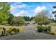 Scenic shot of the home's long driveway, surrounded by lush greenery and mature trees at 424 N Green Cir, Mcdonough, GA 30252