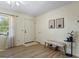 Bright entryway featuring luxury vinyl plank flooring, fresh paint, a decorative bench, and plenty of natural light at 424 N Green Cir, Mcdonough, GA 30252