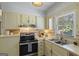 Well-maintained kitchen featuring stainless steel appliances, double bowl sink, and plenty of natural light at 424 N Green Cir, Mcdonough, GA 30252