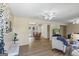 Inviting living room showcasing wood flooring, light neutral paint, ceiling fans, and an open doorway to a dining area with backyard views at 424 N Green Cir, Mcdonough, GA 30252
