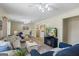 Bright living room open to other rooms, featuring plush seating, natural light, and a cozy ambiance, perfect for entertaining at 424 N Green Cir, Mcdonough, GA 30252