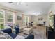 Bright living room open to other rooms, featuring plush seating, natural light, and a cozy ambiance, perfect for entertaining at 424 N Green Cir, Mcdonough, GA 30252