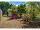 Rear view of a backyard shed surrounded by azaleas and other foliage at 424 N Green Cir, Mcdonough, GA 30252