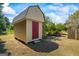 Exterior view of a backyard storage shed with a red door and a gable roof at 424 N Green Cir, Mcdonough, GA 30252