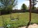 Fenced backyard with mature trees, a small garden, and plenty of space at 2338 Rambling Way, Lithonia, GA 30058