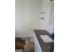 Bathroom features modern vanity, grey countertop, open shelving, and white walls at 2338 Rambling Way, Lithonia, GA 30058