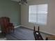 Bedroom with new floors, neutral walls, white trim, a window with blinds, and a chandelier at 2338 Rambling Way, Lithonia, GA 30058