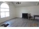 Spacious living room showcasing new floors, a fireplace, a large window, and neutral walls at 2338 Rambling Way, Lithonia, GA 30058