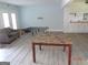 Open-concept living room featuring new floors, white trim, recessed lights, and access to a kitchen area at 2338 Rambling Way, Lithonia, GA 30058