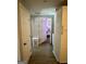 Hallway with wood-look floors and built-in cabinets and laundry. Door opens to bedroom at 2232 Lee Sw St, Covington, GA 30014