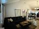 Cozy living room featuring dark sofa, coffee table, and stylish decor, opening to kitchen at 2232 Lee Sw St, Covington, GA 30014