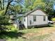 Exterior side view of a cozy home with a small covered porch and truck in the driveway at 2232 Lee Sw St, Covington, GA 30014