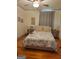 Cozy bedroom featuring hardwood floors, ceiling fan, and blue and white bedding at 6127 Floyd Ne St, Covington, GA 30014