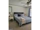 A comfortable bedroom features a blue paisley comforter, bedside tables, and a ceiling fan at 6127 Floyd Ne St, Covington, GA 30014