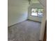 Bright carpeted room with a large window offering natural light, ideal for a bedroom or office at 6127 Floyd Ne St, Covington, GA 30014