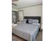 Bright bedroom featuring a large window, bedside tables, a soft paisley comforter and wardrobe at 6127 Floyd Ne St, Covington, GA 30014