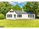 Charming brick home featuring a welcoming blue front door and lush green lawn at 6127 Floyd Ne St, Covington, GA 30014