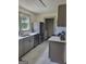 Bright kitchen with stainless steel appliances, shaker cabinets, and a window over the sink at 6127 Floyd Ne St, Covington, GA 30014