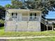 Inviting exterior of a home featuring a covered porch, a stone foundation, and a well-maintained lawn at 7 Ivy St, Porterdale, GA 30014