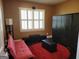 Versatile bonus bedroom featuring a futon and seating with ample natural light from the shuttered windows at 1598 Renaissance Ne Dr, Conyers, GA 30012