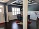 Elegant dining room featuring dark hardwood floors, coffered ceilings, and a modern chandelier above the dining table at 1598 Renaissance Ne Dr, Conyers, GA 30012