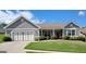 Charming single-story home with well-manicured lawn, landscaping and attached two car garage at 1598 Renaissance Ne Dr, Conyers, GA 30012
