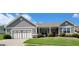 Charming single-story home with well-manicured lawn, landscaping and attached two car garage at 1598 Renaissance Ne Dr, Conyers, GA 30012