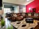 Spacious living room with a cozy leather sofa, bright colored walls, and hardwood floors at 1598 Renaissance Ne Dr, Conyers, GA 30012