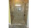 Luxurious tile shower featuring a glass door, built-in bench, and recessed lighting at 1598 Renaissance Ne Dr, Conyers, GA 30012