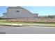 Side view of the backyard, showcasing a mulched area and a partial view of neighboring homes at 609 Francis Ave, Peachtree City, GA 30269