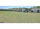 Large, grassy backyard featuring a playset, swing, trampoline, and a privacy fence at 609 Francis Ave, Peachtree City, GA 30269